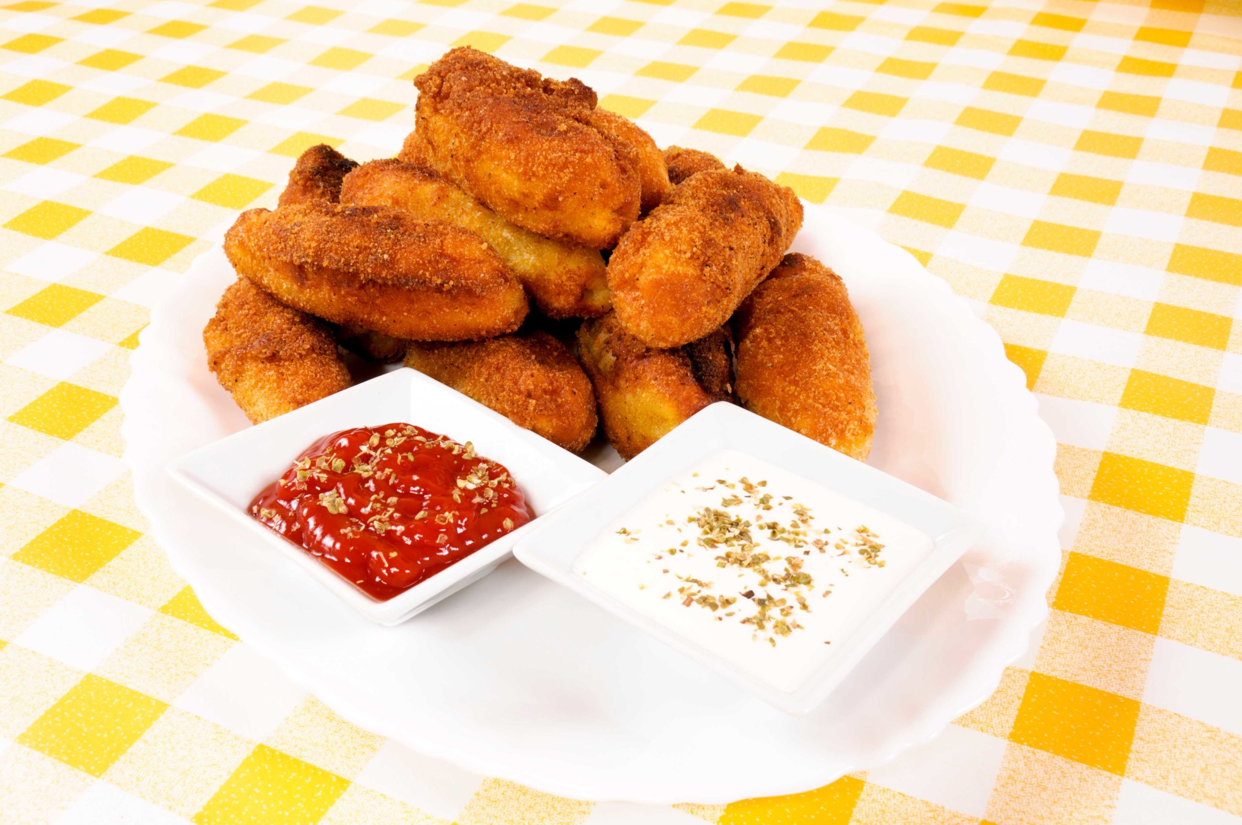 Fried foods on a table with sauces
