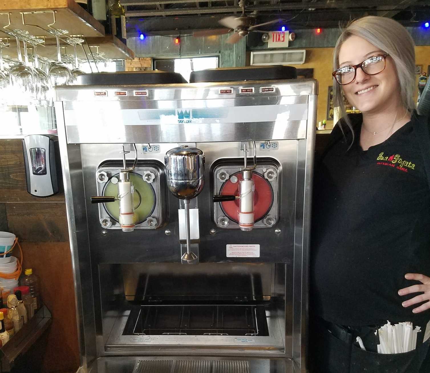 restaurant manager with frozen margarita machine