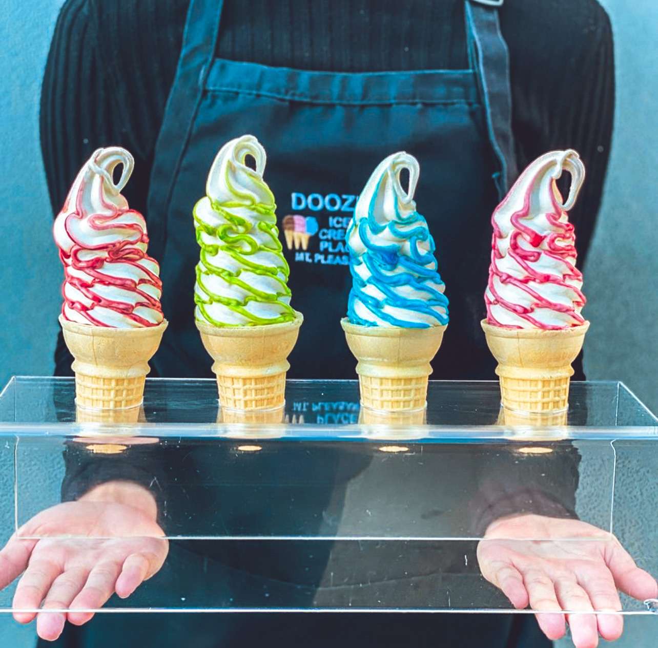 ice cream shop worker with four ice cream cones from Flavor Burst equipment