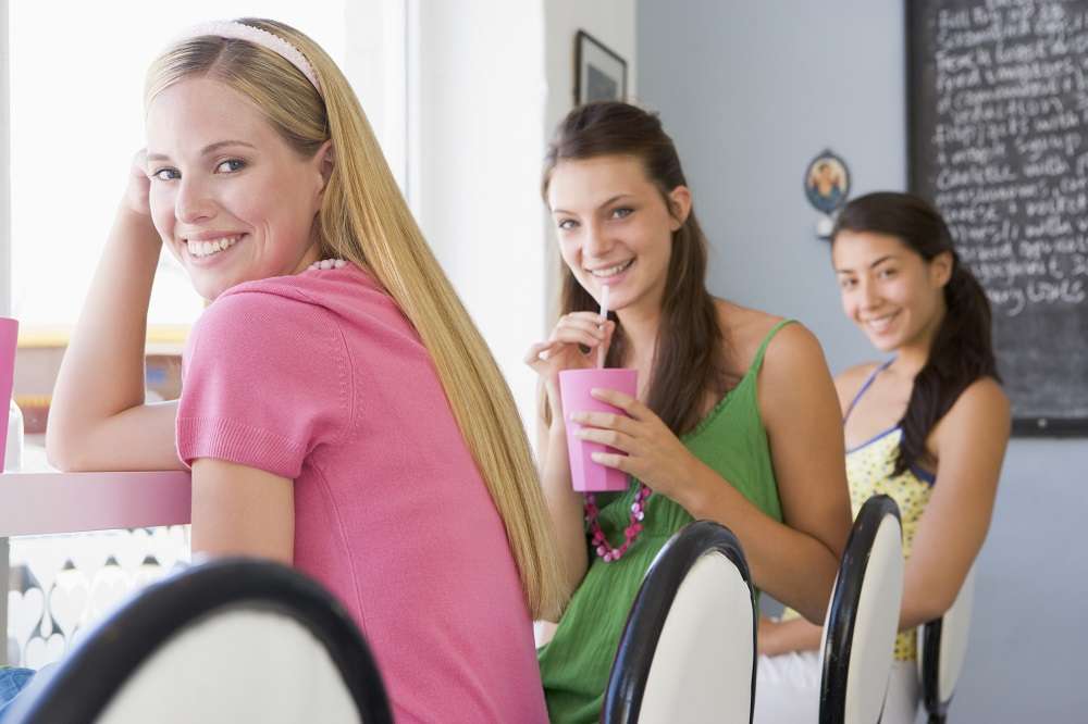 girls drinking smoothies from commercial smoothie machine